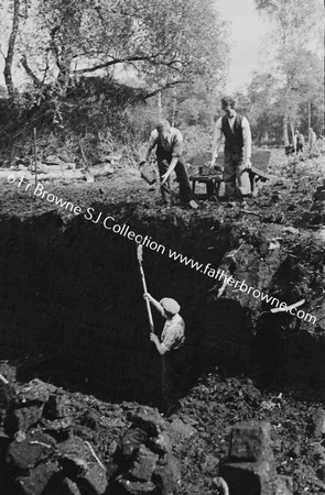 MEN DIGGING PEAT BY HAND